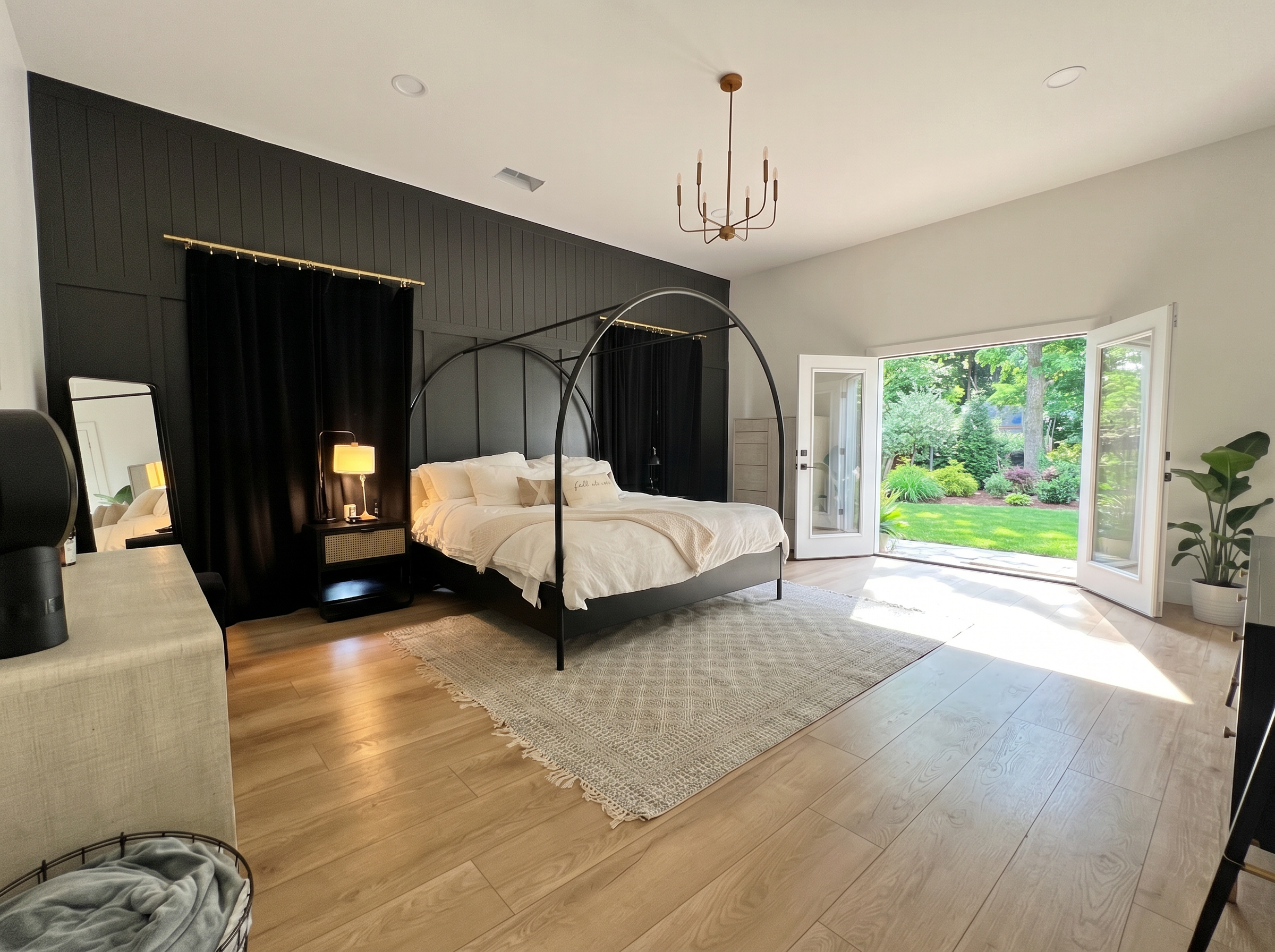 French doors leading to backyard from primary bedroom renovation — natural light and hardwood floors — May Construction