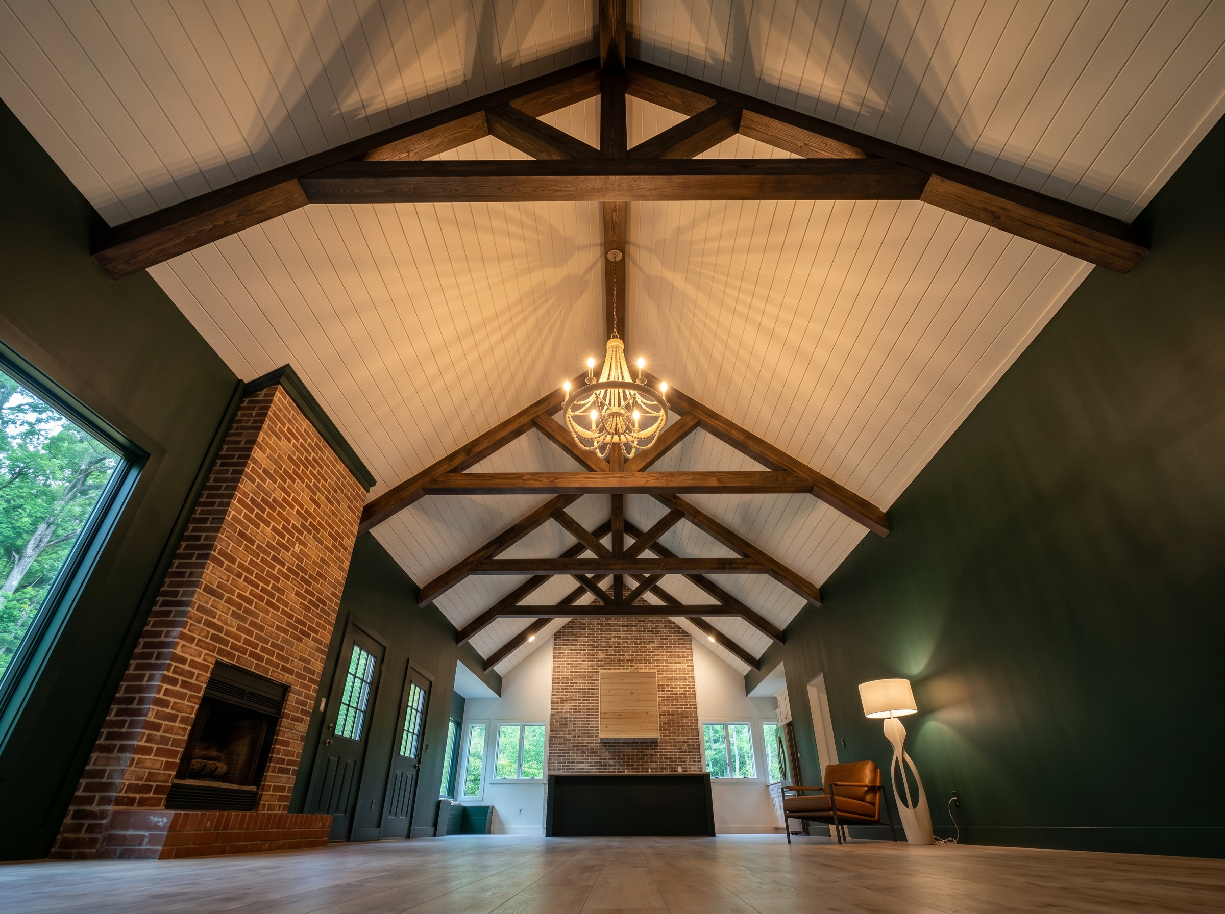 Vaulted ceiling with exposed wood beams and chandelier in open concept living room — custom new build — May Construction